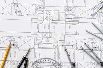Paper with technical drawings and work tool on table. place of work.