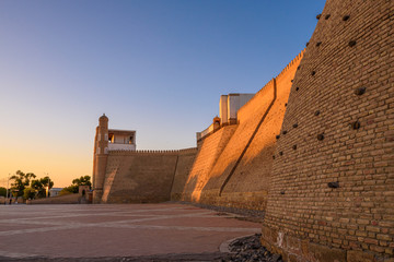 Obraz na płótnie Canvas Ancient 12th century fortress Ark Citadel of Bukhara during sunset in Uzbekistan