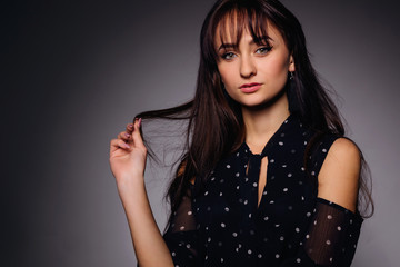 close-up brunette girl with evening make-up in blue polka dot dr