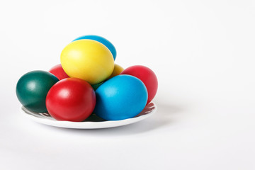 Colored easter eggs in white plate on a background. Isolate. White background.