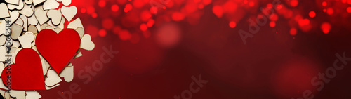 Happy Valentine's Day background panorama banner long - Wooden hearts isolated on red bokeh texture, top view with space for text