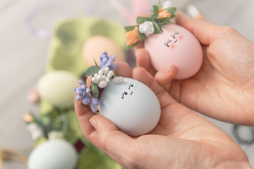 woman makes cute decorative eggs for easter holiday. do-it-yourself easter gifts concept. cute...
