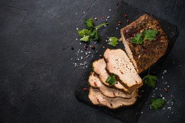 Baked pork meat ham on black kitchen table.