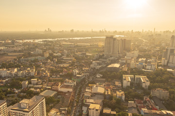 Obraz premium Bangkok / Thailand - 8 March 2019: Bird's eye view to show the beautiful sky and heavy traffic above the city view of Bangkok that is full of harmful PM 2.5 dust that is harmful to the body.