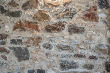 The wall background is made of stone, highlighted from above.