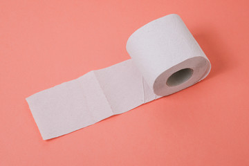 Expanded roll of toilet paper on a pink background. A place to write text. Template for creative greetings or message passing.