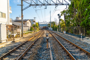 Fototapeta na wymiar Japanese railway with a train run through with Kyoto City.