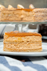 Plate with delicious caramel cake close up