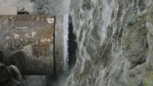 Horizontal drilling rig cutting utilities tunnel hole into limestone rock