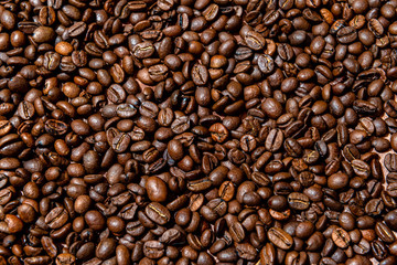 Close-up of brown, roasted coffee beans  background