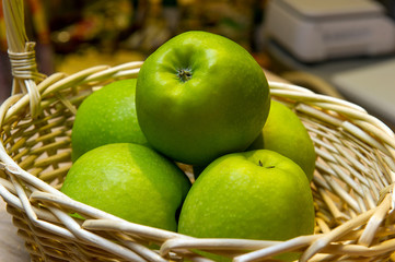 still life, apples in a basket, in the window of a grocery market