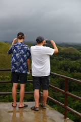 Fototapeta na wymiar tourists admire the natural beauty of the chocolate hills on bohol island in the philippines