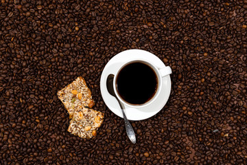 White coffee mug and cookies on the coffee beans background - image