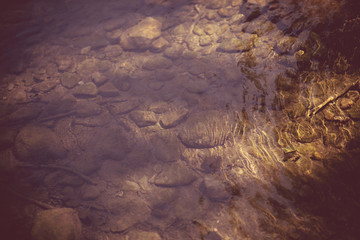 Background with lake stones washed by little waves.