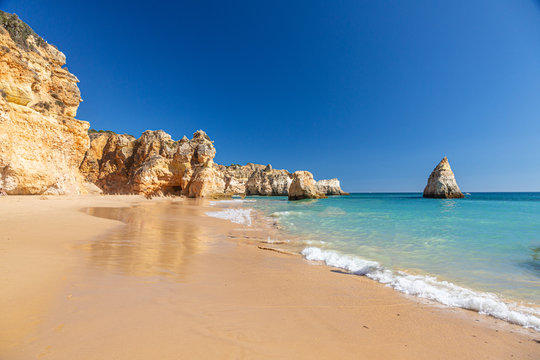 View on typical cliffy beach at Algarve coastline in Portugal in summer