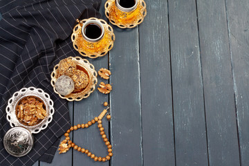 Nut balls dessert served with coffee on dark wooden table, top view