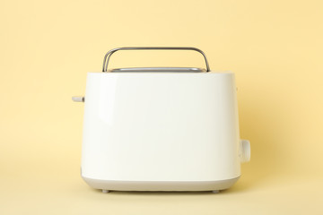 Toaster for bread on beige background, space for text