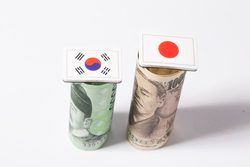 Obraz premium Korean won and Japanese Yen banknote money and flag