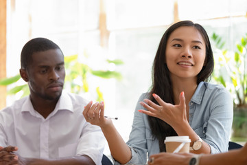 Obraz premium Motivated Asian female employee talk at office meeting