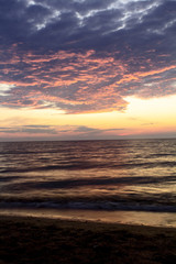 background of sunset on the sea, birds fly among the clouds lit by the rays of the sun, beautiful landscape