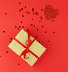 rectangular box wrapped in brown kraft paper and tied with red thin silk ribbon in red
