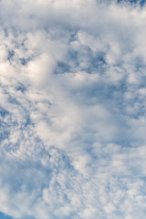 Naklejka na ściany i meble Beautiful cirrus clouds completely cover the blue sky. Positive abstract background