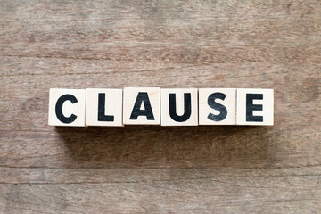Fototapeta na wymiar Letter block in word clause on wood background