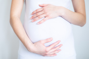 Fototapeta na wymiar young pregnant woman caressing her tummy