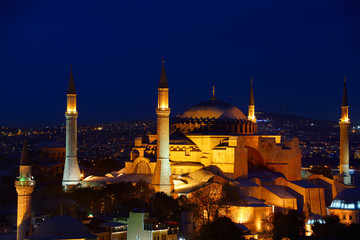 Fototapeta na wymiar Night lights on Hagia Sophia and Firuz Aga Mosque at twilight in Istanbul Turkey