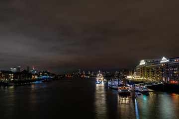 Fototapeta na wymiar Illuminated ship on a river Thames in the dark, London. A shot from Tower bridge.