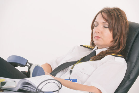 Woman airline pilot sleeping in the office