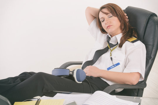 Woman airline pilot sleeping in the office