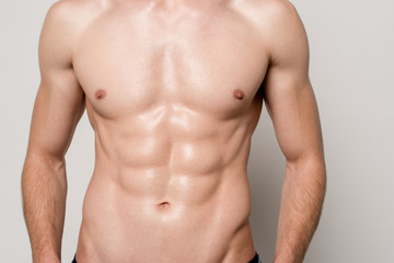 cropped view of sexy man with muscular torso isolated on grey