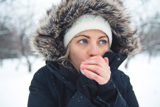 The girl with cold hand in winter season