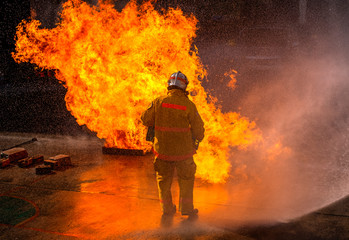 The Firefighters demonstrating fire fighting.