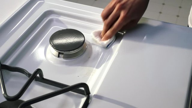 Cook top being cleaned with sponge