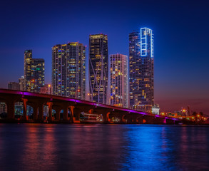 Fototapeta na wymiar night city downtown cityscape buildings panorama miami sea bridge water river skyscraper urban lighting blue sky dusk