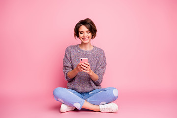 Portrait of her she nice attractive lovely charming pretty cute cheerful cheery brown-haired girl sitting using cell 5g app isolated over pink pastel color background