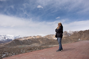 Travelers thai women people travel visit and posing with view landscape of Leh Ladakh Village from viewpoint of Thiksey monastery and Namgyal Tsemo Gompa in Jammu and Kashmir, India  in winter season