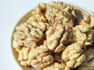 A macro close up view of walnut on a small plate.