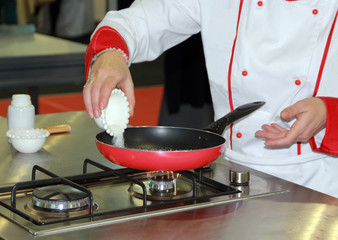 Chef, white sugar poured into a pan to fried.