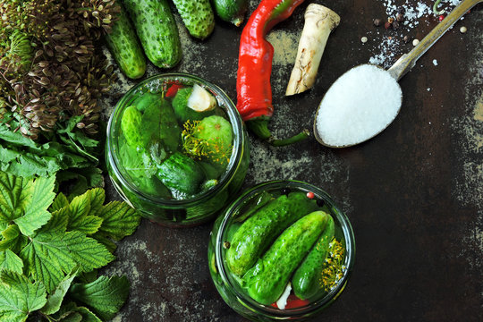 Cooking pickled cucumbers. Pickling cucumbers. Cucumbers in jars, spices, salt and herbs. - Powered by Adobe
