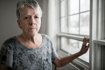 A sad lonely 70 years old senior in is apartment