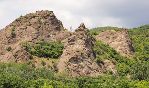 A view on the Valac carst with green overgrowth and the blue sky in the background.