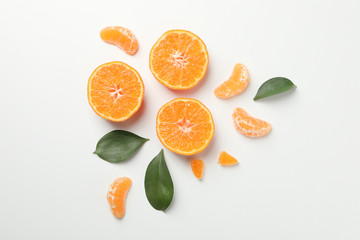 Mandarins and leaves on white background, top view