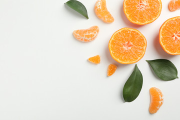 Mandarins and leaves on white background, top view