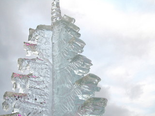 Ice figure in the form of a fir tree carved against the sky