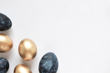 Happy Easter card. Frame with gold and blue Easter eggs. Copy space for text. Isolated on a white background. Top view. 