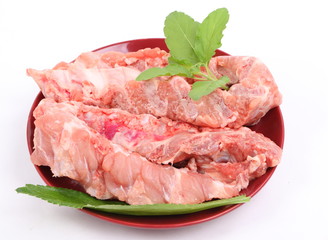 Raw Pork Ribs in red plate On White Background 