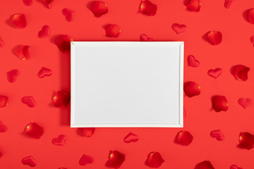 Valentine's Day background. Blank frame for text, beautiful rose petals on red background. Valentine day concept. Flat lay, top view, copy space